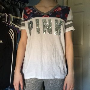 White shirt with flower designs.